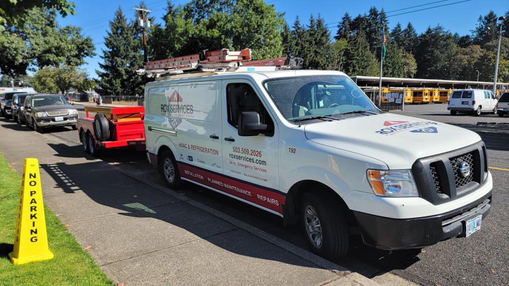 Rox Services van and equipment trailer at a school campus in the Portland metro area